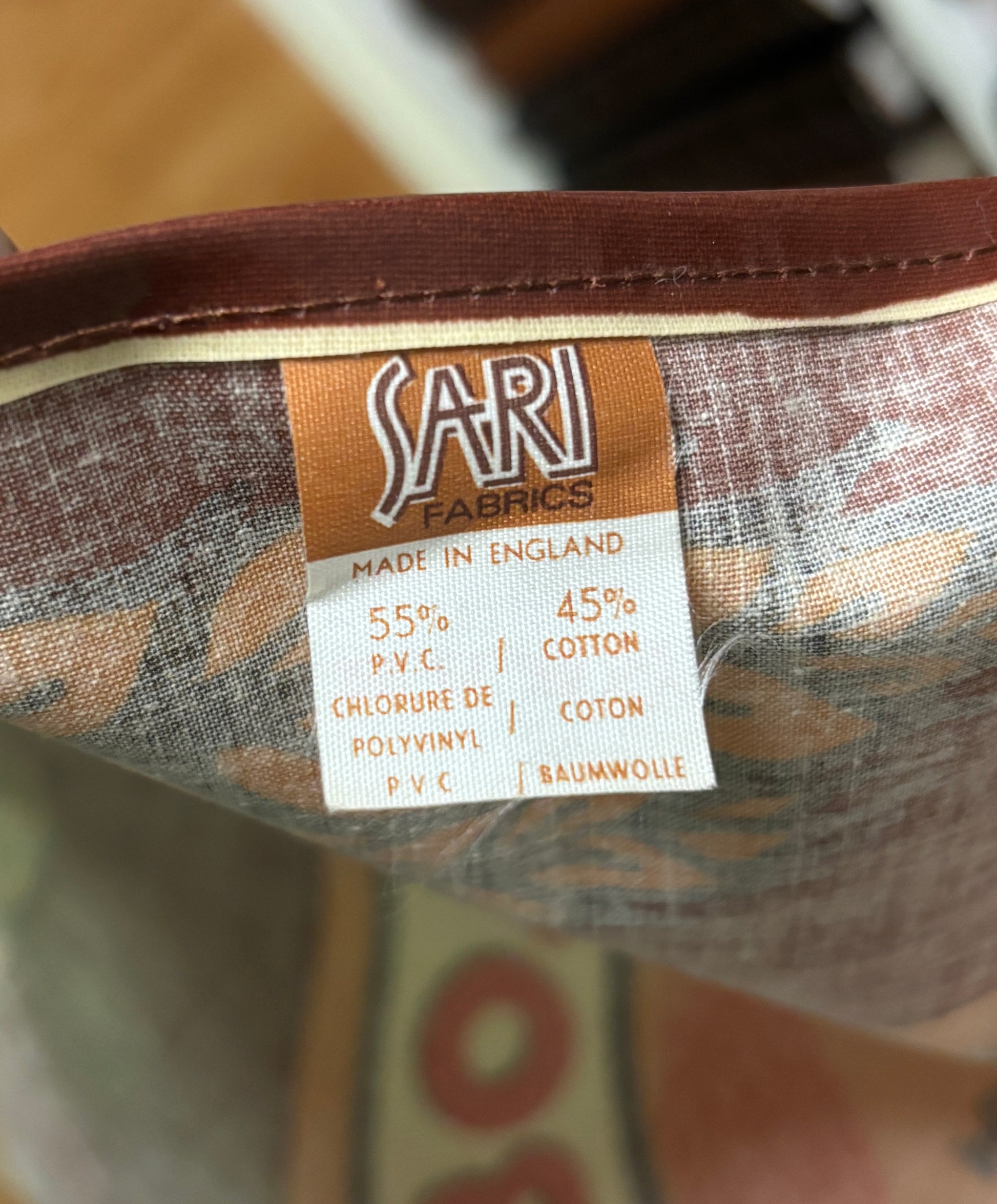 Fabric label on a product with 'Sari Fabrics' branding and material information.