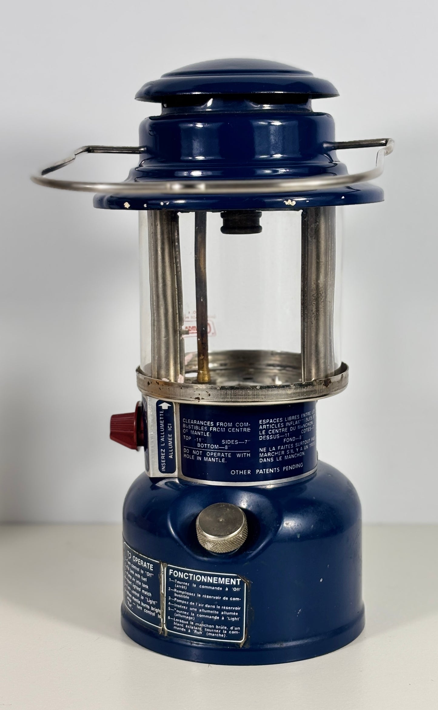 Blue lantern with metal components on a white background