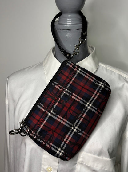 Plaid bag on a mannequin wearing a white shirt against a gray background