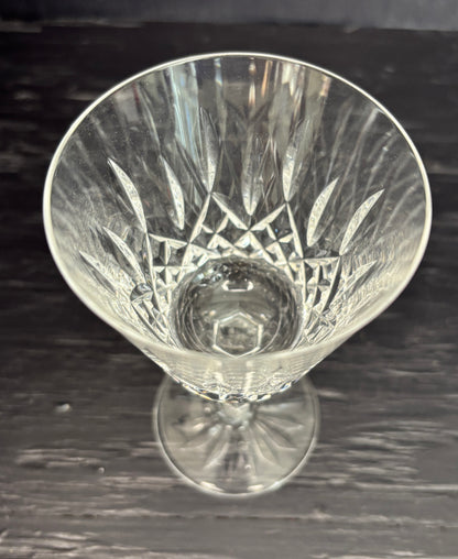 Clear glass with intricate cut patterns on a dark surface
