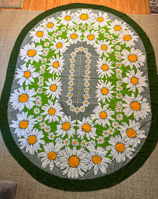 Decorative round tablecloth with daisy pattern on a green background