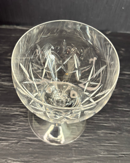 Clear glass with intricate cut design on a dark surface