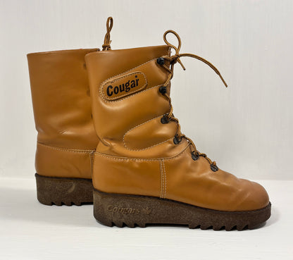 Pair of tan leather boots with 'Cougar' branding on a white background
