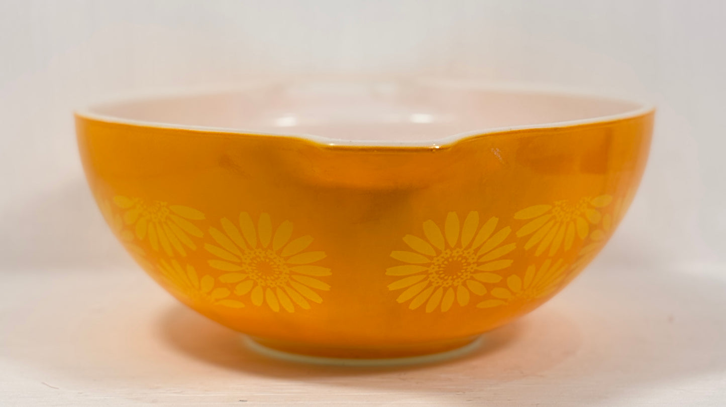 Orange bowl with yellow floral patterns on a white background