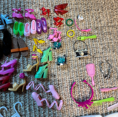 Collection of colorful miniature shoes and accessories on a textured surface