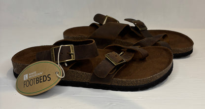 Brown sandals with a visible brand tag on a white background
