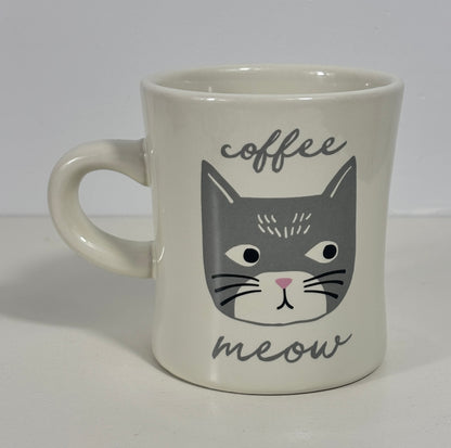 Mug with a cat face design and 'coffee meow' text on a white background