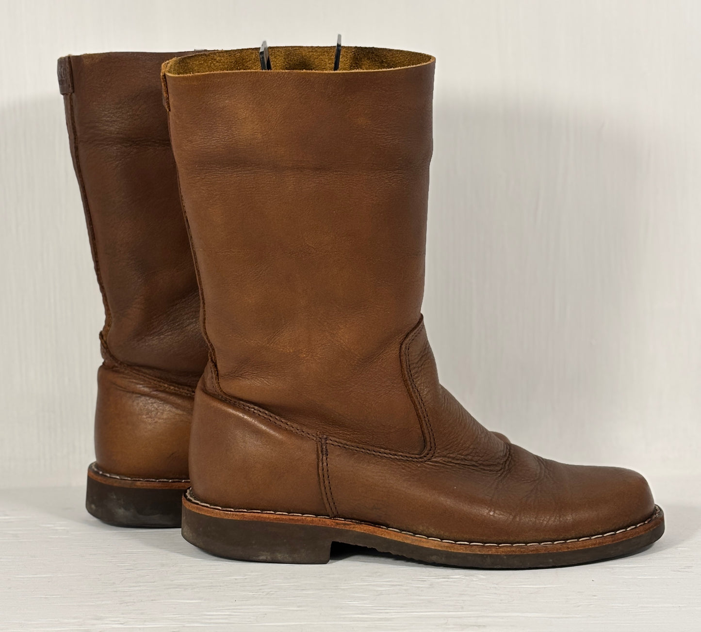 Pair of brown leather boots on a white background