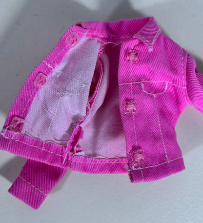 A bright pink denim-style doll jacket with a matching pink fabric lining and pink buttons, photographed on a plain light background.