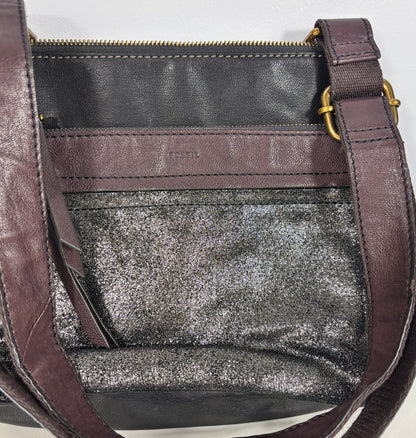 Close-up of a handbag with a glittery interior and visible brand name.