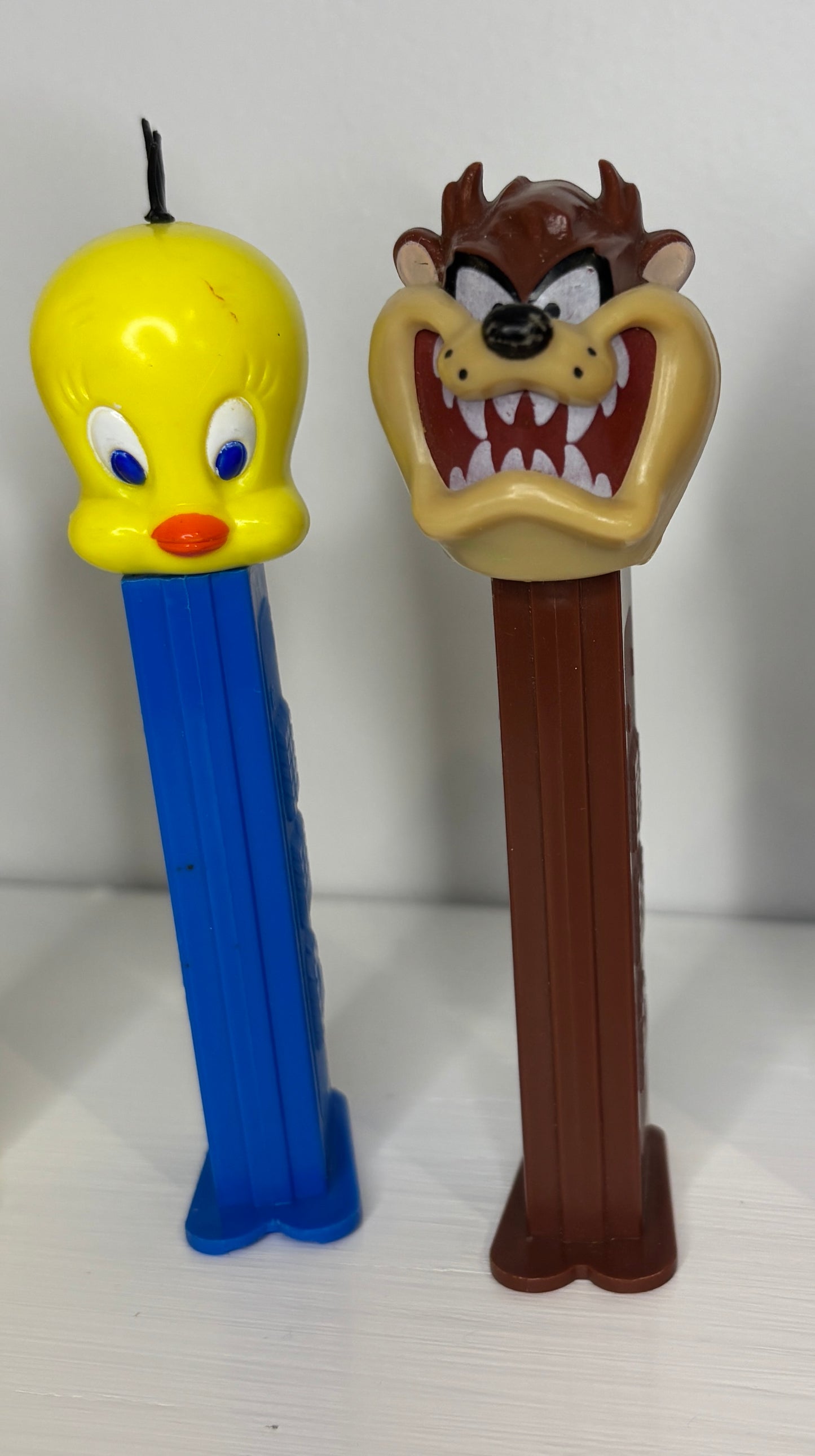 Two Pez dispensers featuring Looney Tunes characters on a white background
