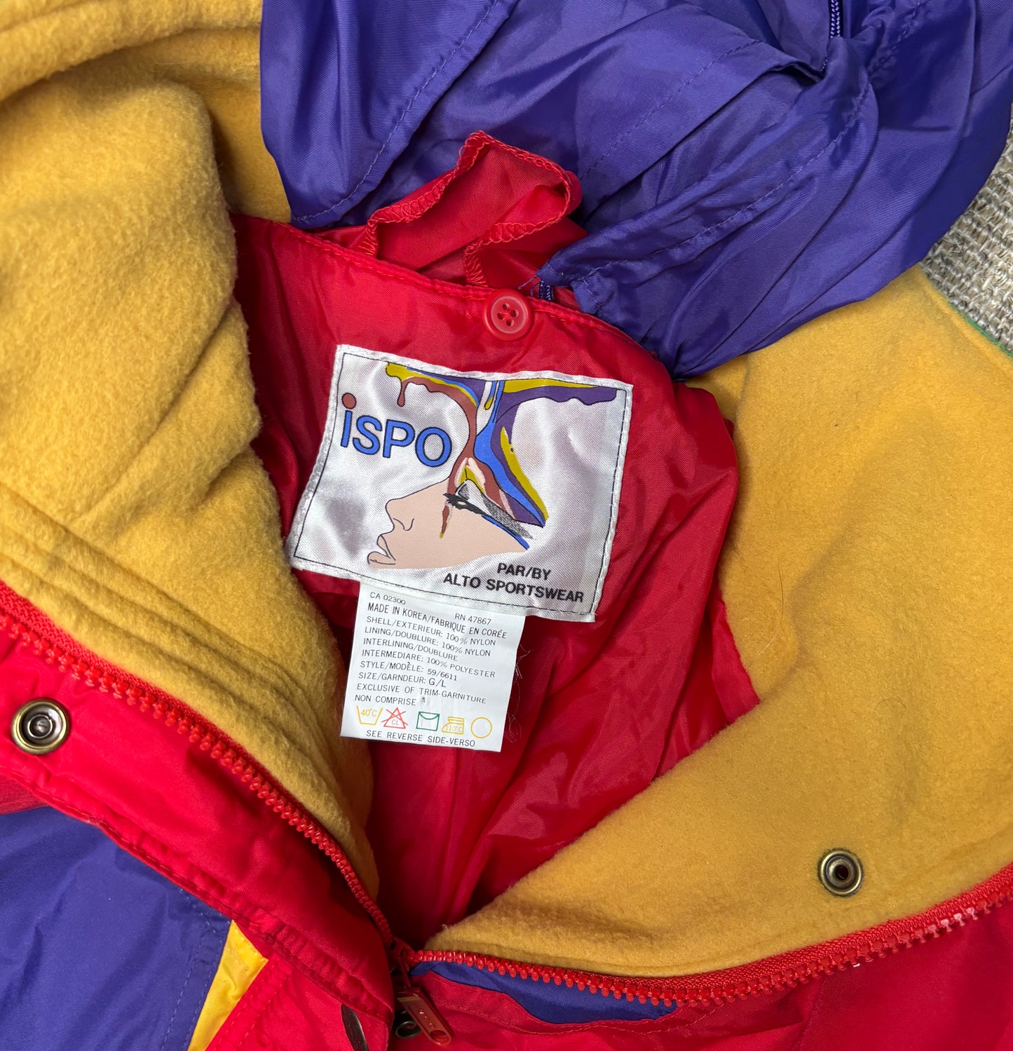 Colorful jacket with a visible ISPO label on a textured background