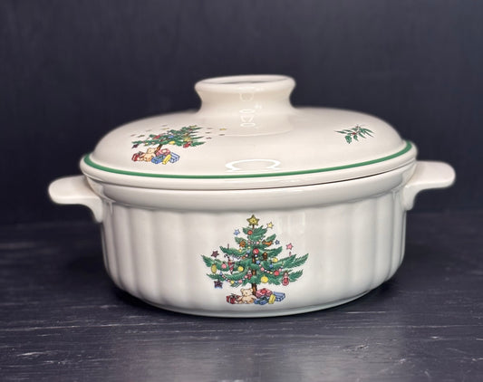 White ceramic casserole dish with Christmas tree design on a dark background
