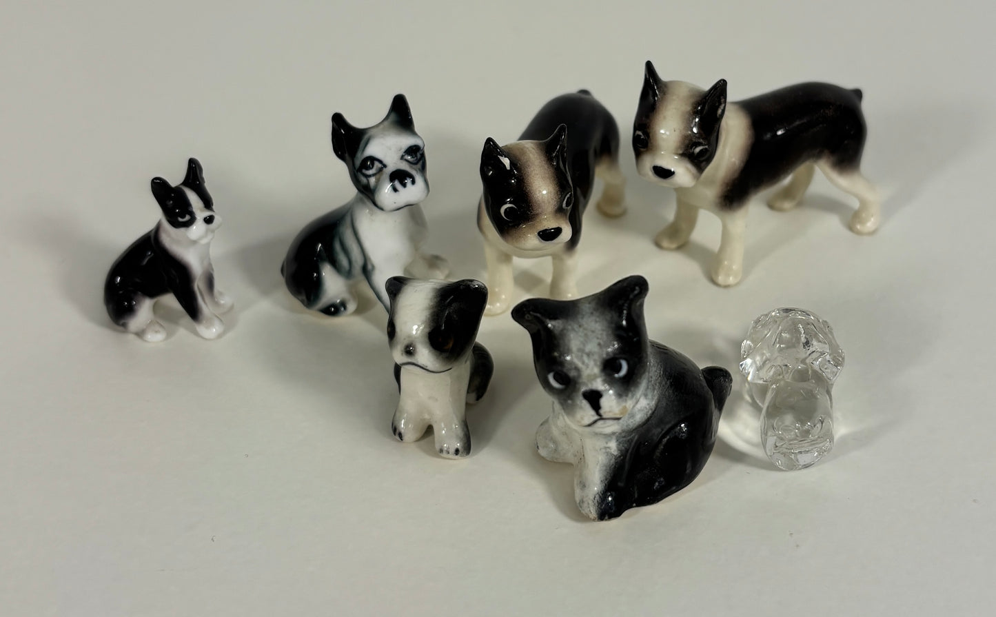 Set of black and white dog figurines on a light gray background