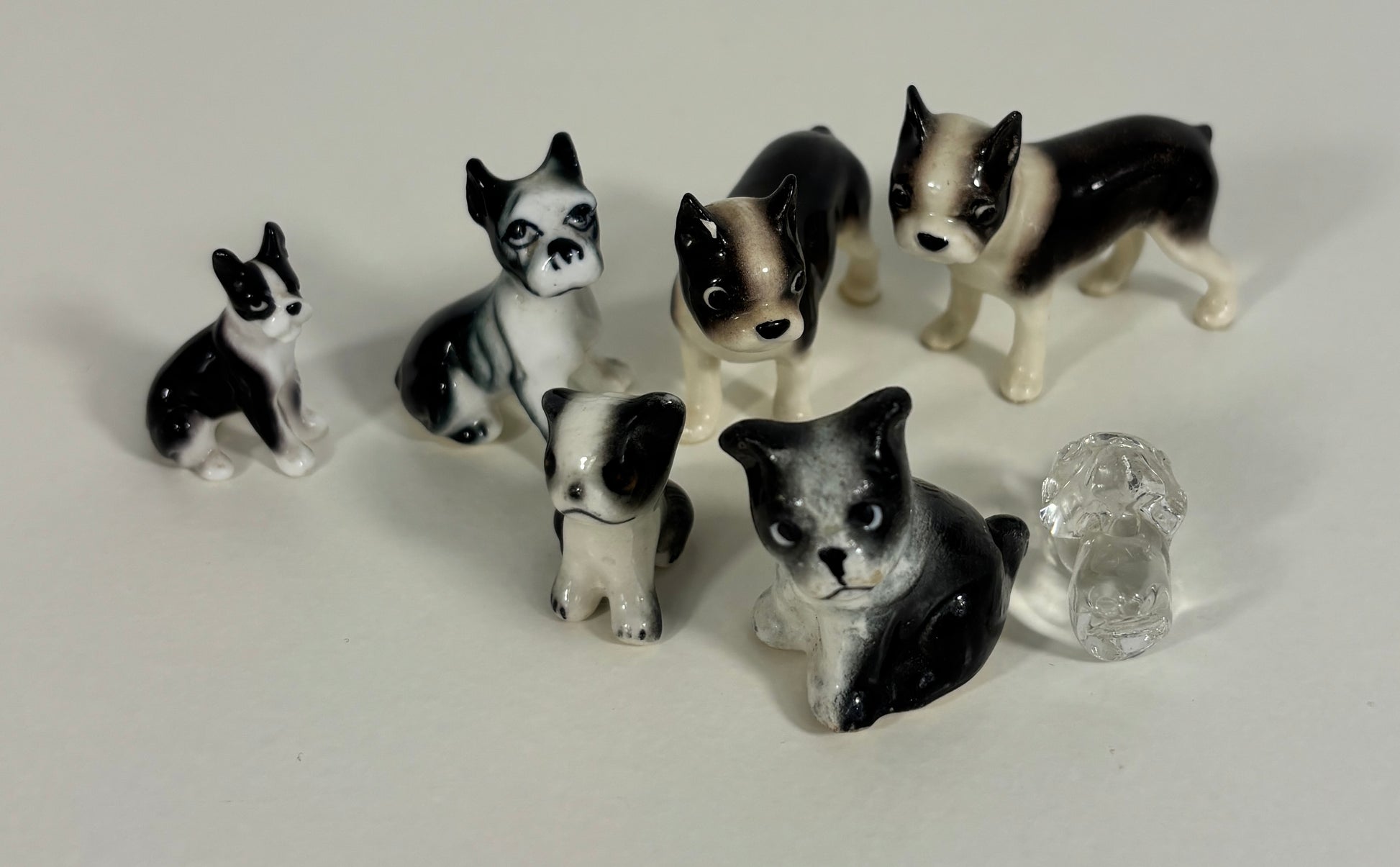 Set of black and white dog figurines on a light gray background