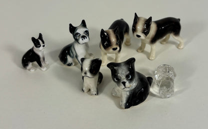 Set of black and white dog figurines on a light gray background