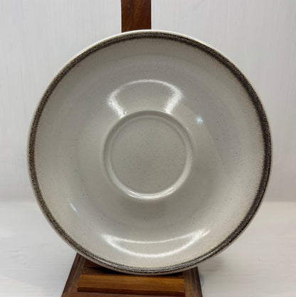 Ceramic bowl with a textured rim on a white background