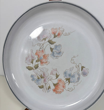 White plate with floral design on a white background