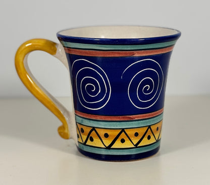 Ceramic mug with decorative patterns on a white background