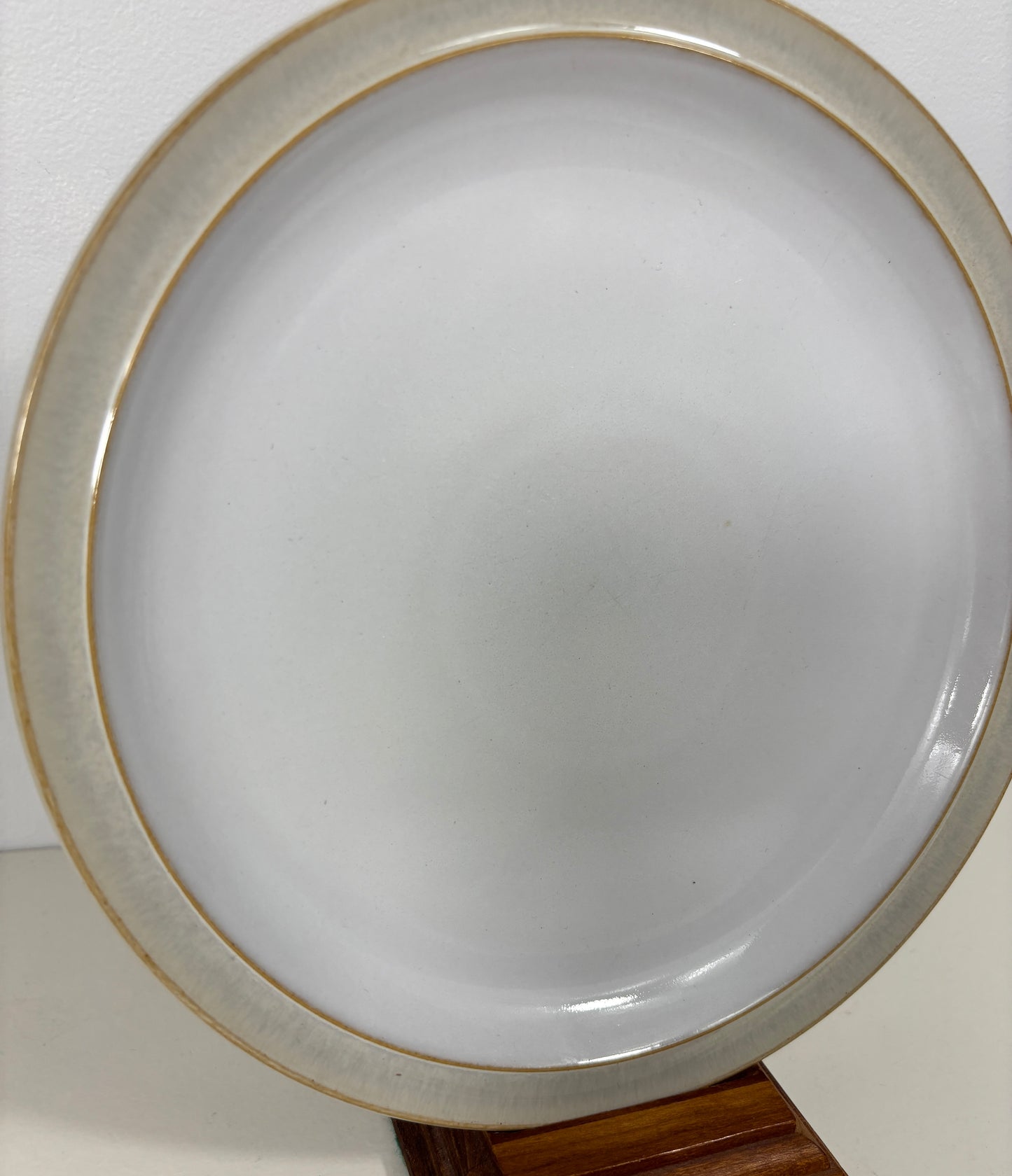 Round magnifying glass with a gold rim on a white background