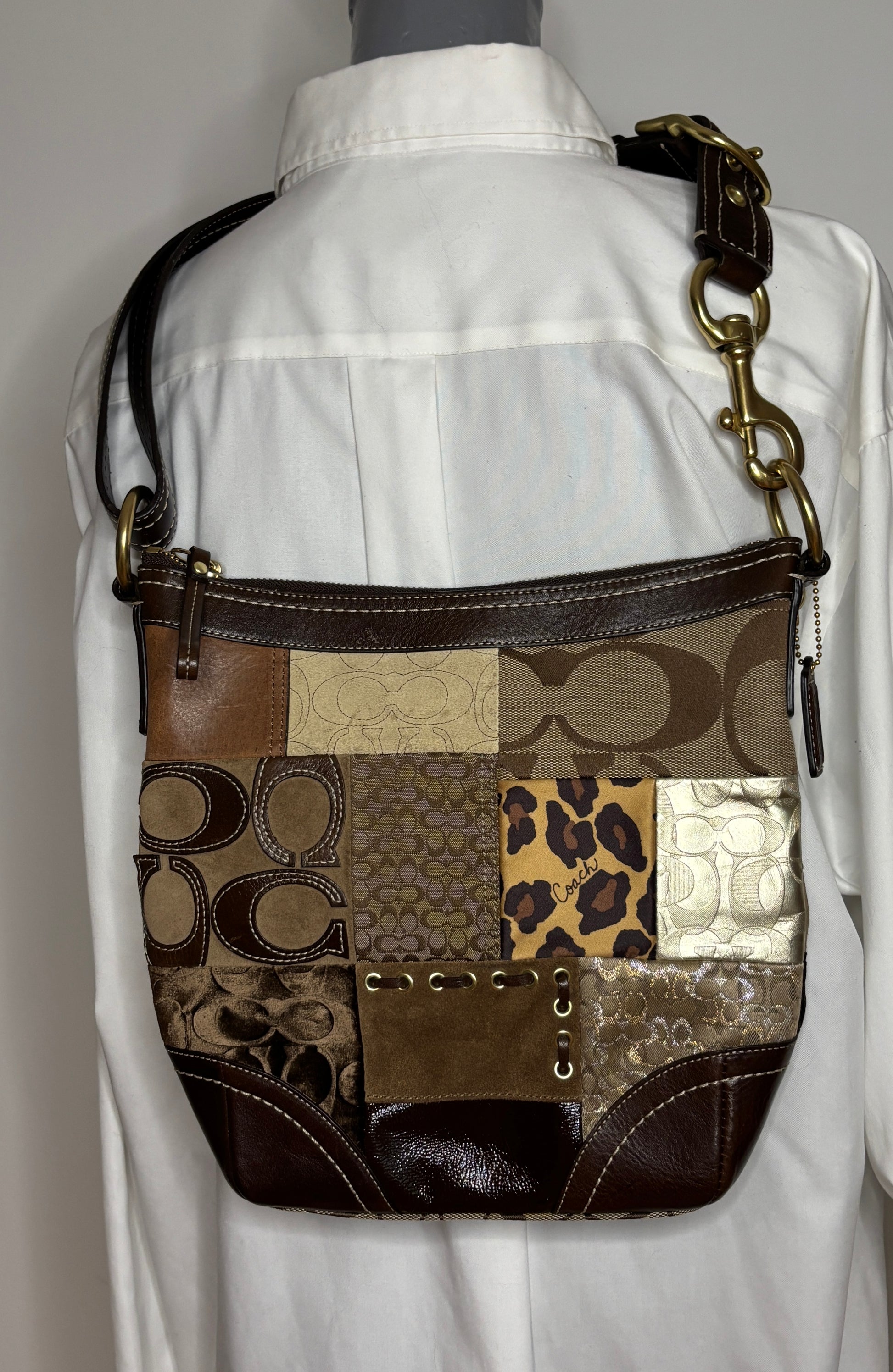 Patchwork patterned handbag on a mannequin with a white shirt background