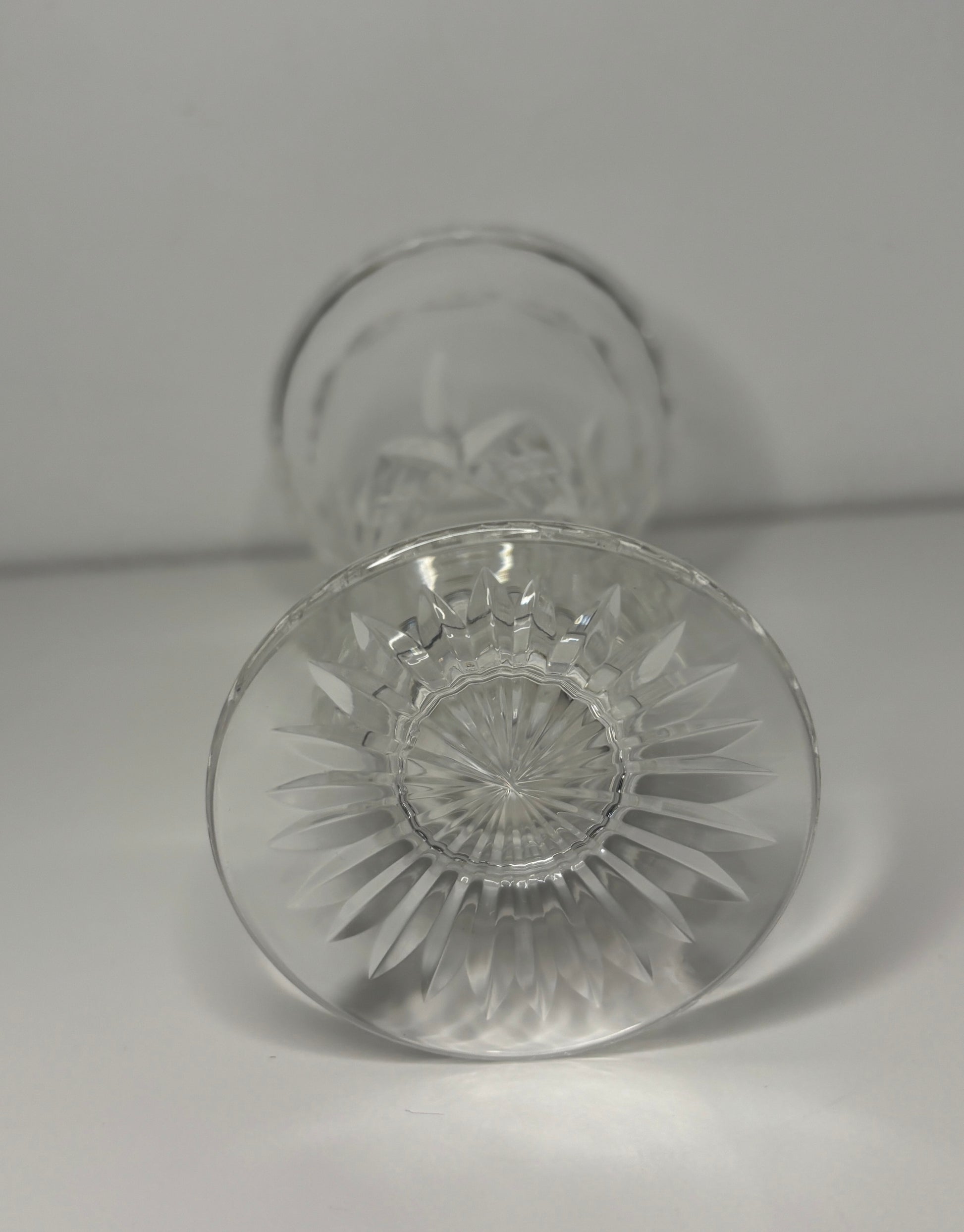 Clear glass with intricate design on a light gray background
