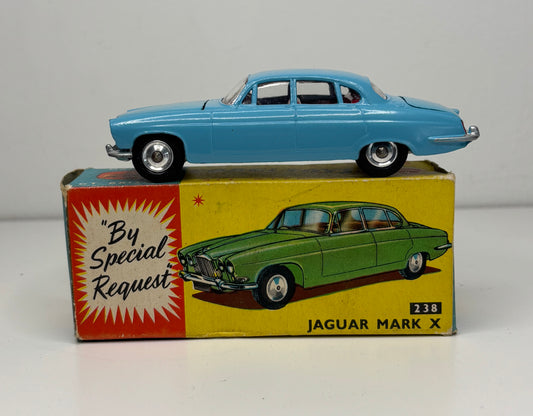 Model car on top of its box with a Jaguar Mark X illustration and text 'By Special Request' on a gray background.