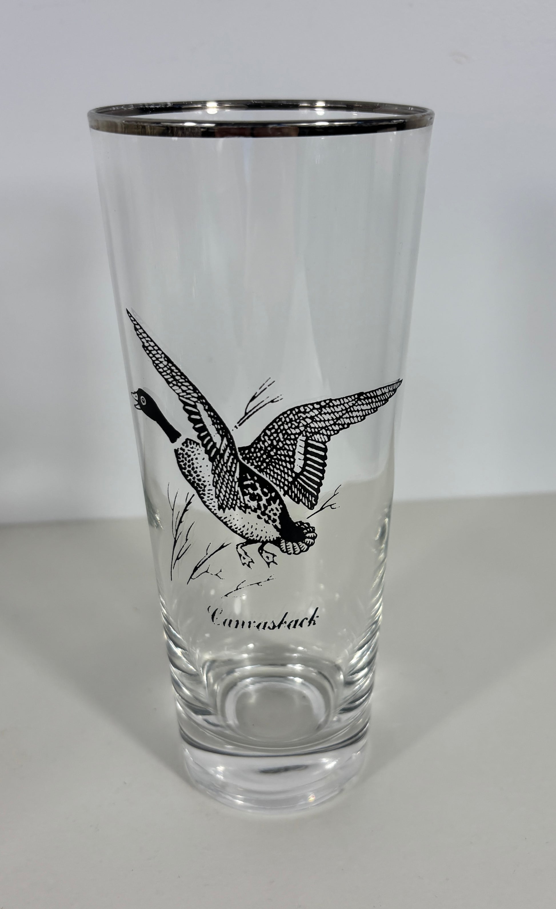 Clear glass with black bird illustration and 'Canvasback' text on a white background