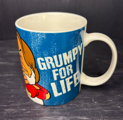 Mug with cartoon character and 'Grumpy for Life' text on a dark surface