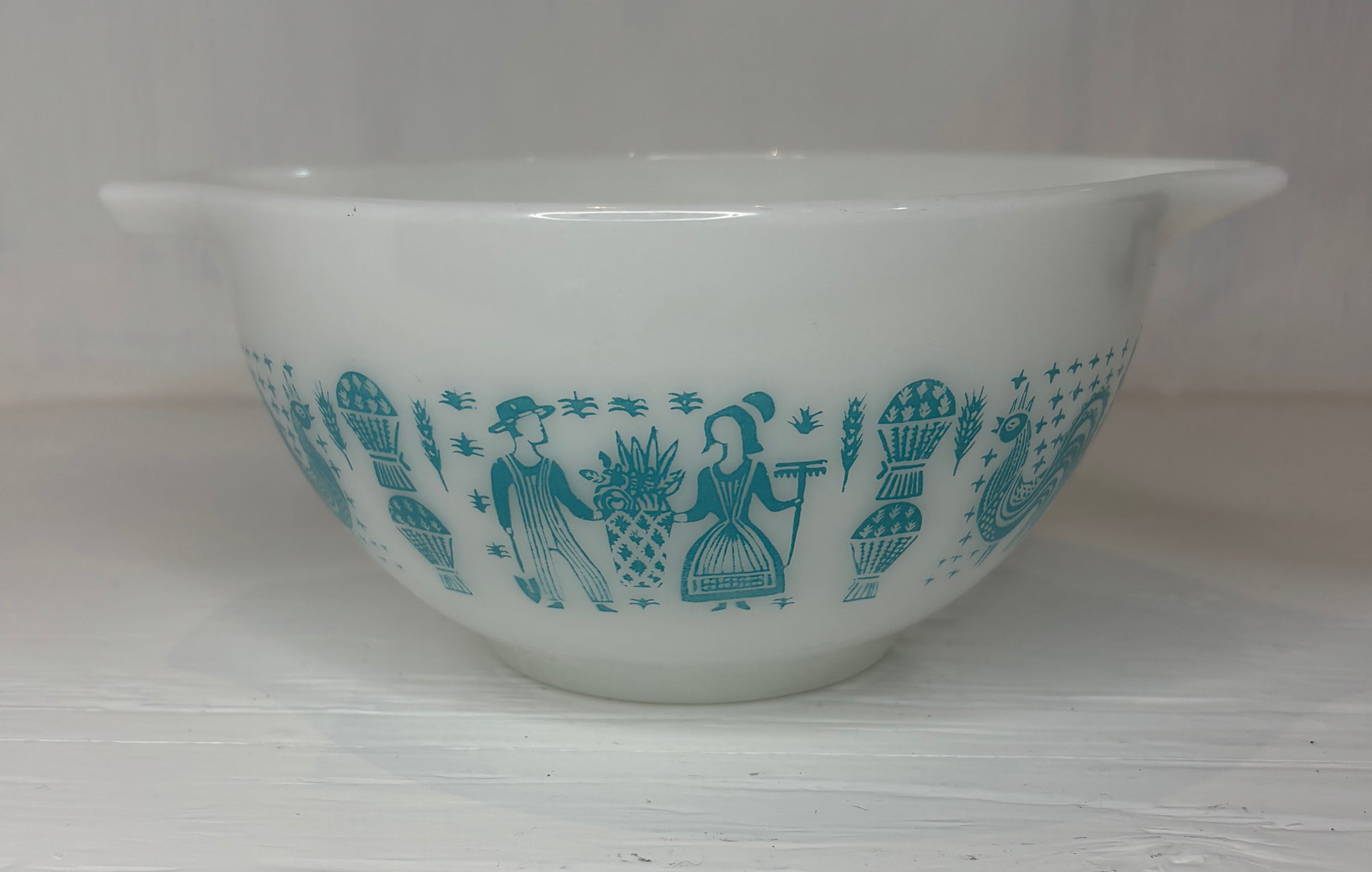 White mixing bowl with blue decorative pattern on a white background