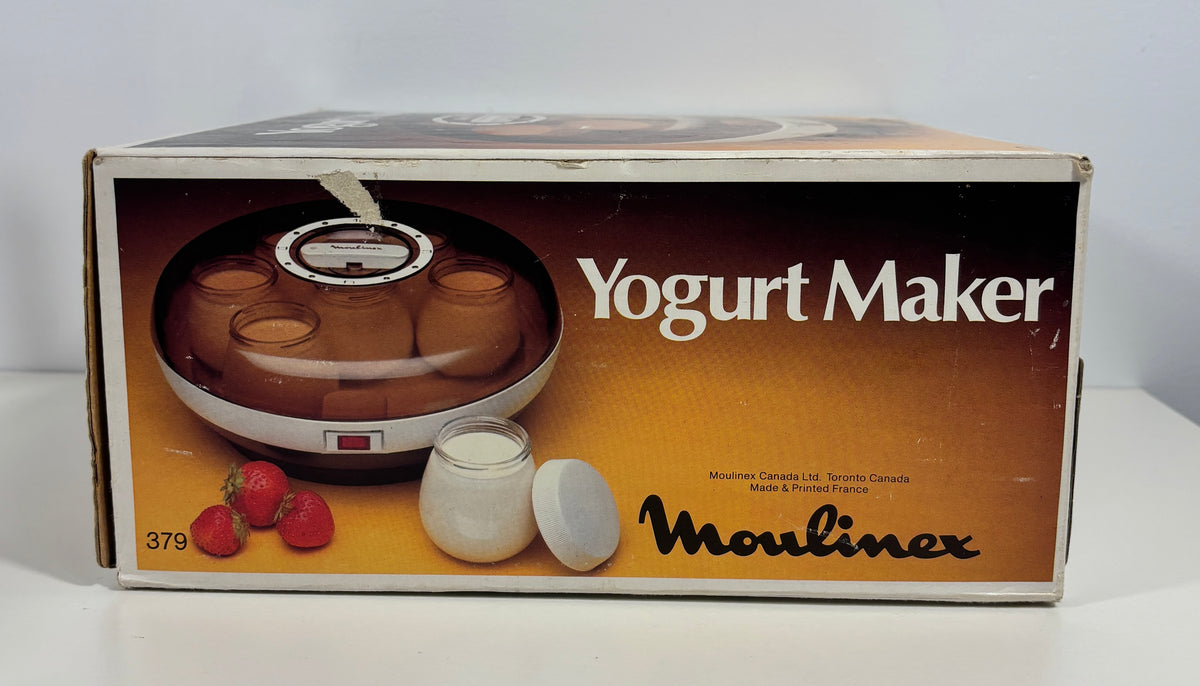 Vintage Moulinex Yogurt Maker retail box, showing the appliance and a small yogurt jar on the front, photographed on a white surface against a white background.