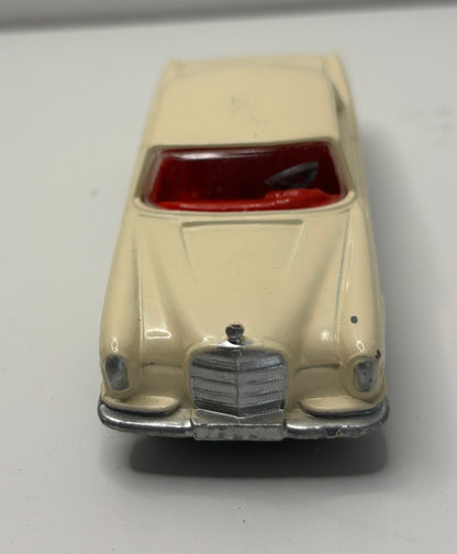 Beige toy car with a red interior on a white background
