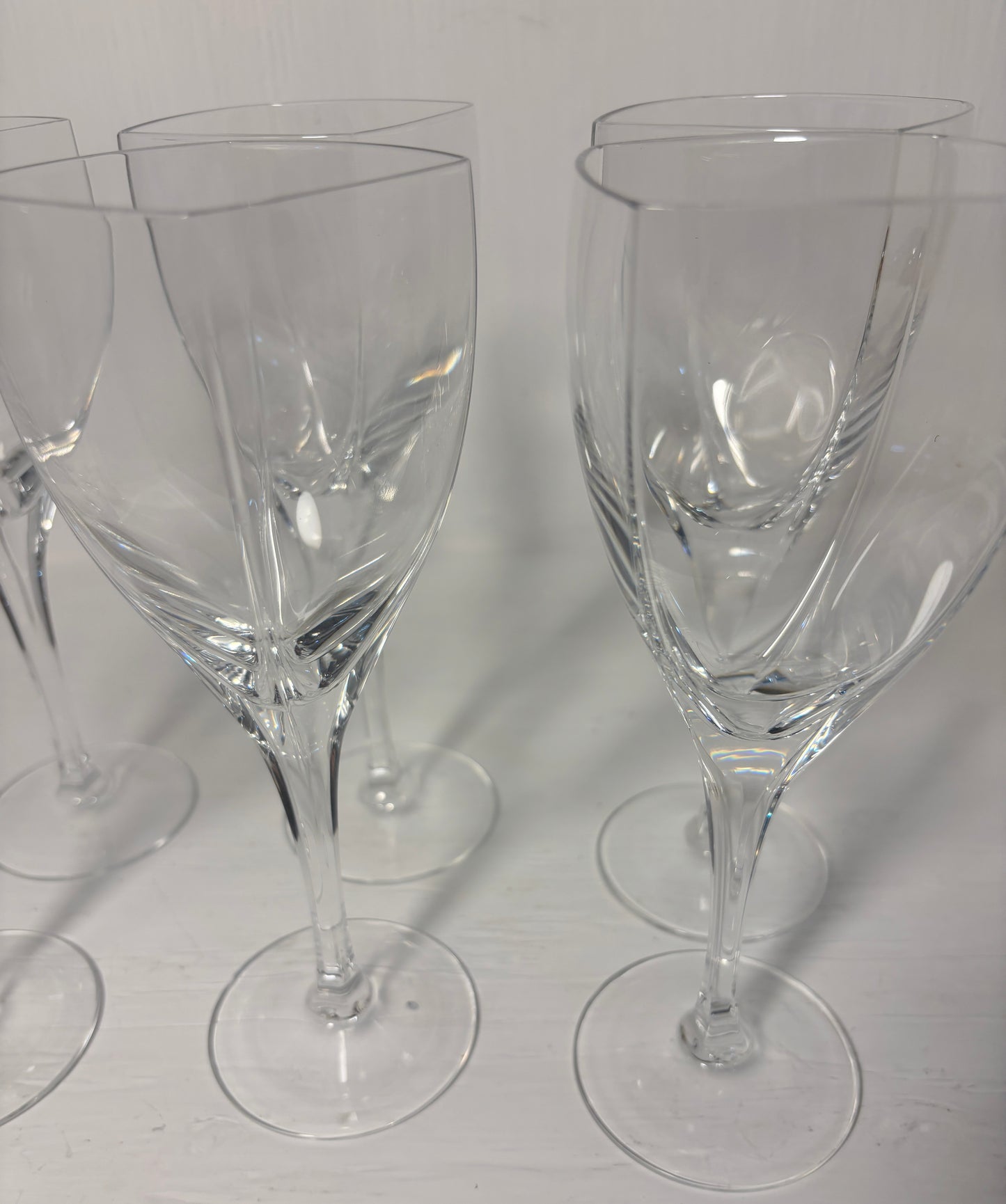 Set of clear wine glasses on a light gray background