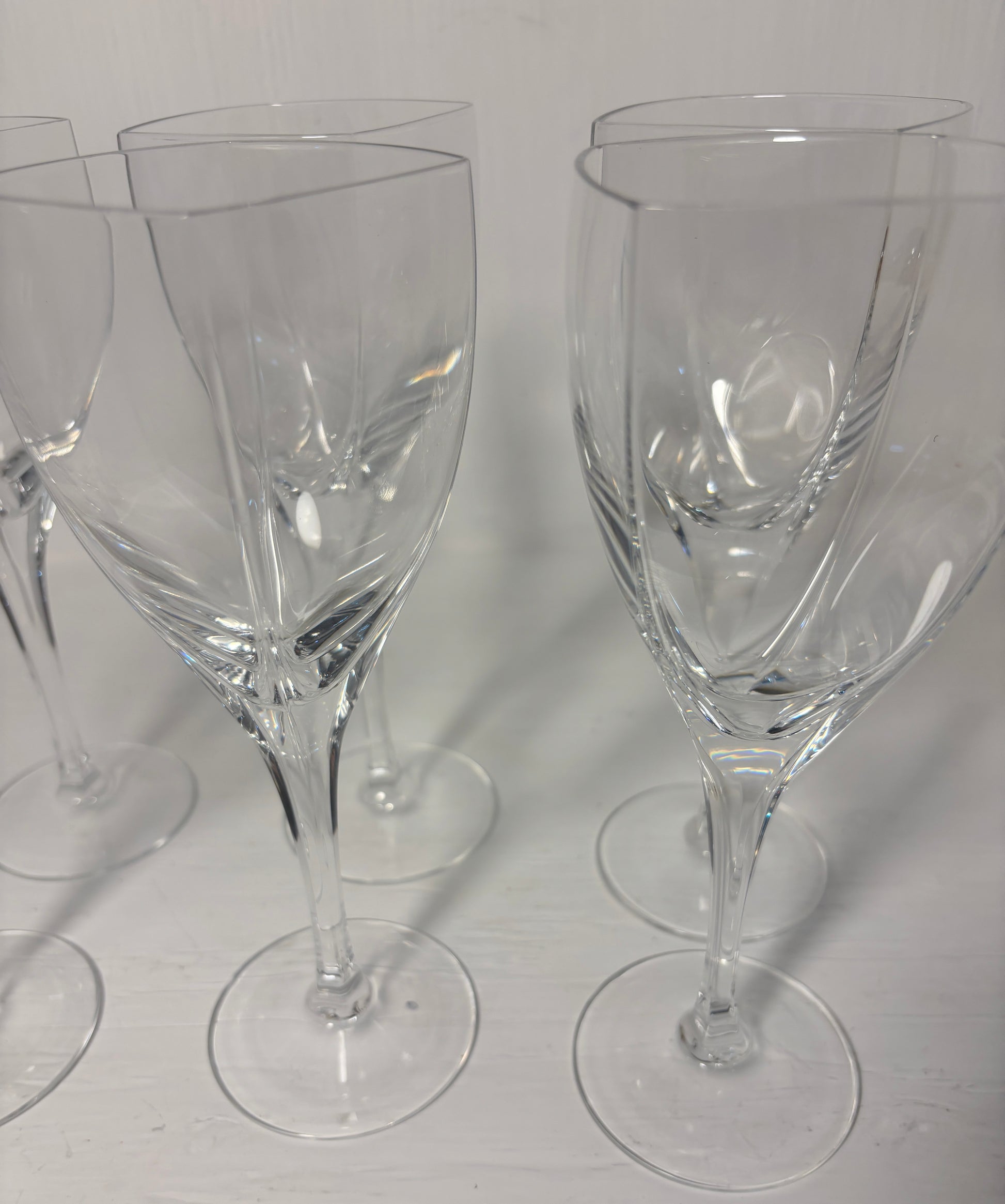 Set of clear wine glasses on a light gray background