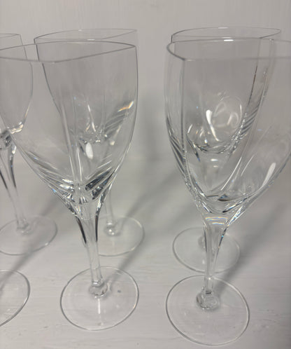 Set of clear wine glasses on a light gray background