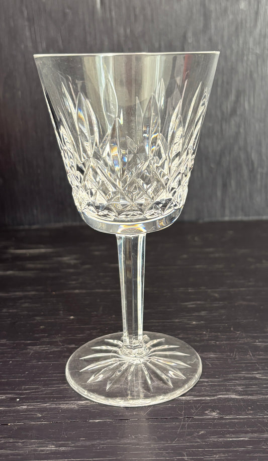 Crystal wine glass on a dark wooden surface