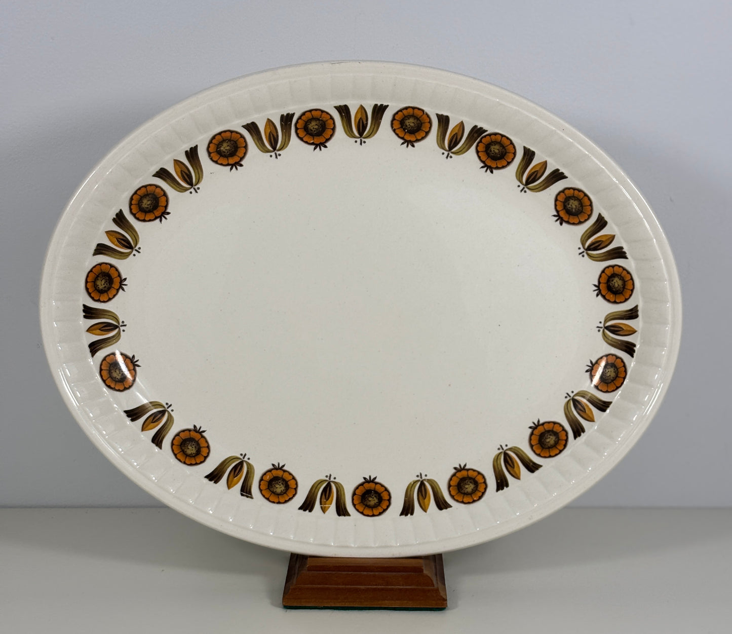 Decorative ceramic platter with brown floral patterns on a plain background