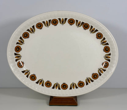 Decorative ceramic platter with brown floral patterns on a plain background