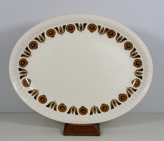 Decorative ceramic platter with brown floral patterns on a plain background