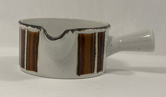 Ceramic gravy boat with brown stripes on a white background