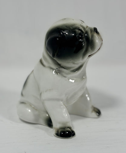Small ceramic bulldog figurine on a white background