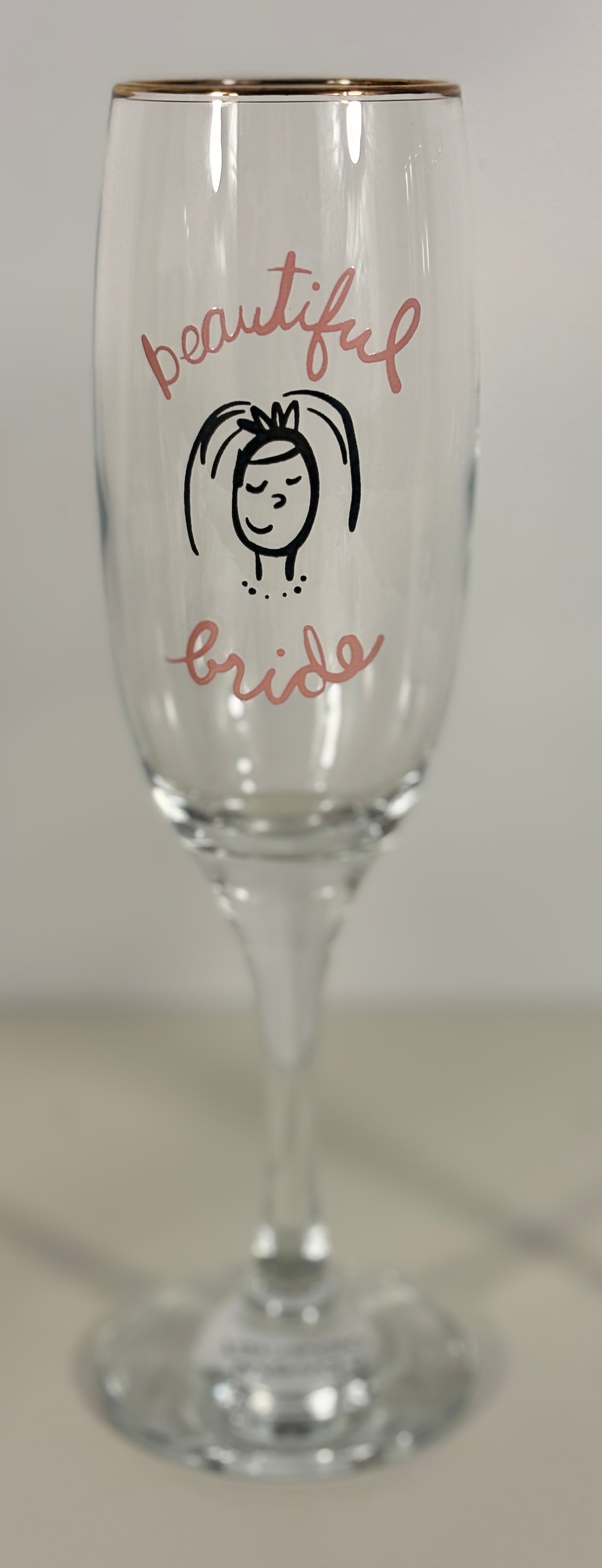 Champagne flute with 'beautiful bride' text and a small illustration on a white background