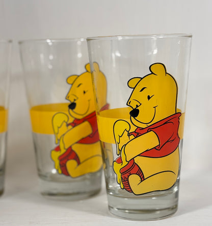 Two glass tumblers with Winnie the Pooh design on a white background