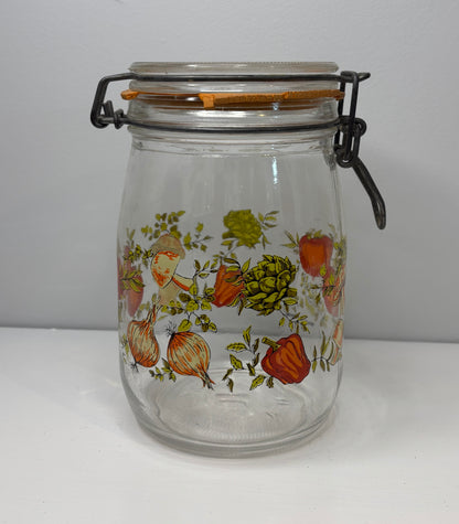 Clear glass jar with floral design on a white background