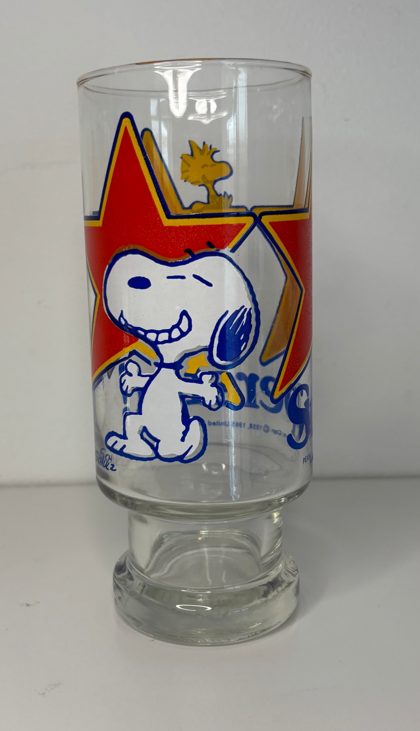 Clear glass with Snoopy design featuring a red star on a white background