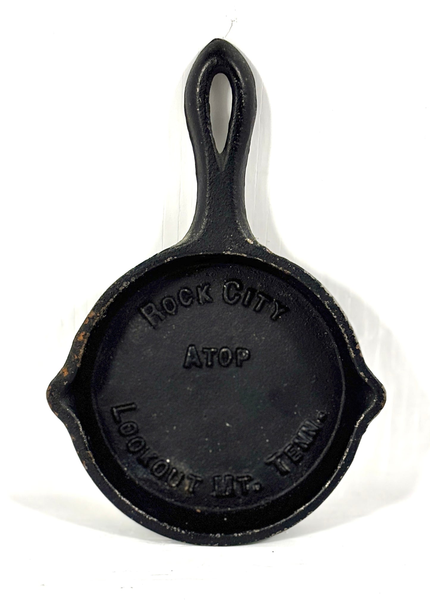 Cast iron skillet with 'Rock City Atop' branding on a white background
