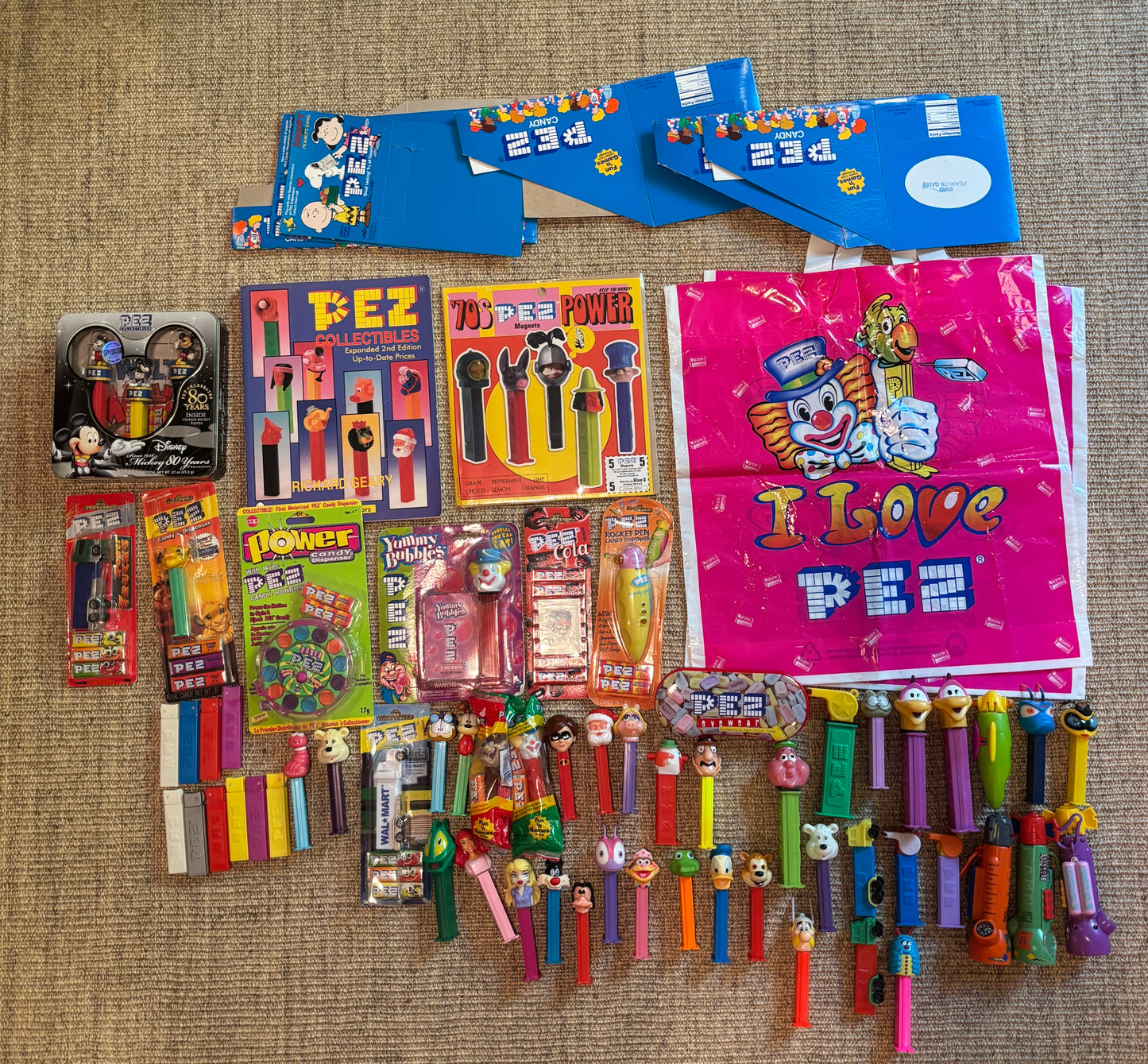 Collection of Pez dispensers and packaging on a textured surface
