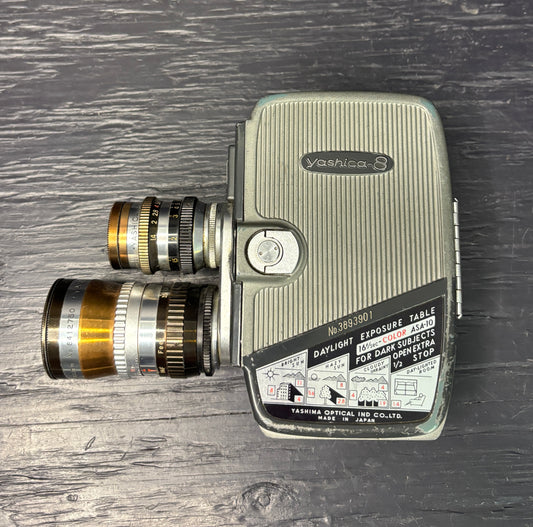 Vintage Yashica movie camera on a wooden surface
