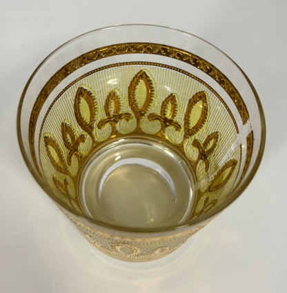 Decorative glass with gold patterns on a white background