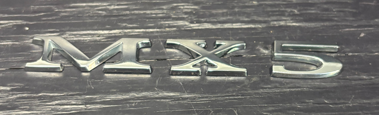 MX5 logo on a metallic surface